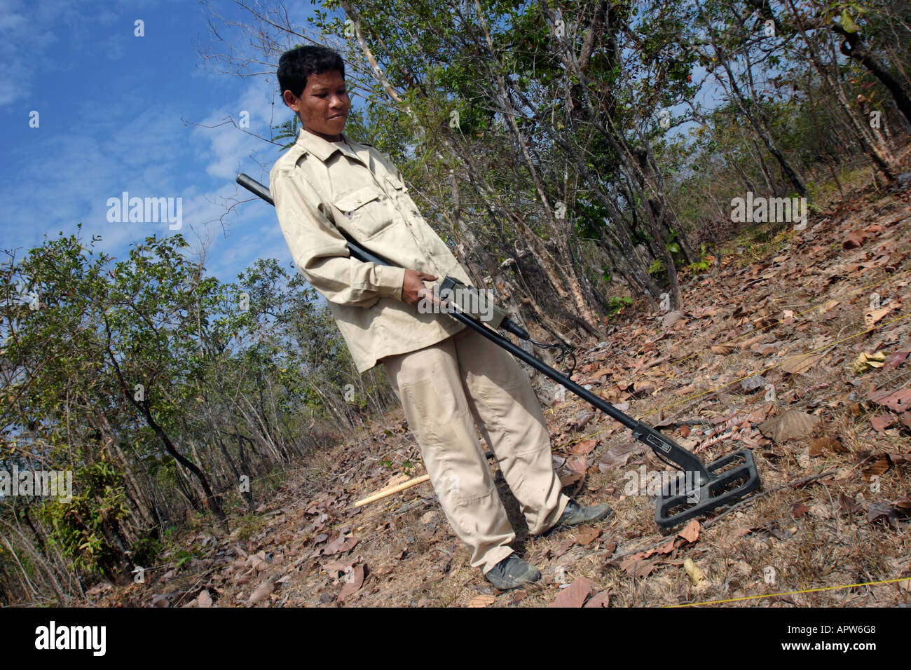 Member of UXO Lao, a government de-mining group clears an area of unexploded ordnance in Saravan, southern Laos. Stock Photo