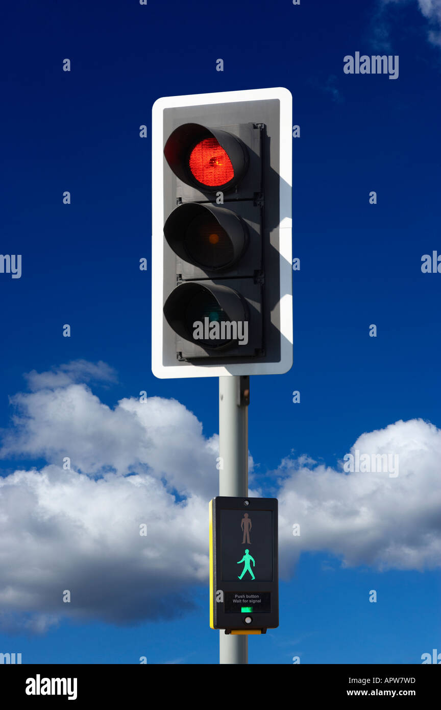 RED ROAD TRAFFIC LIGHT AND PEDESTRIAN CROSSING CONTROL BOX WITH BLUE SKY Stock Photo