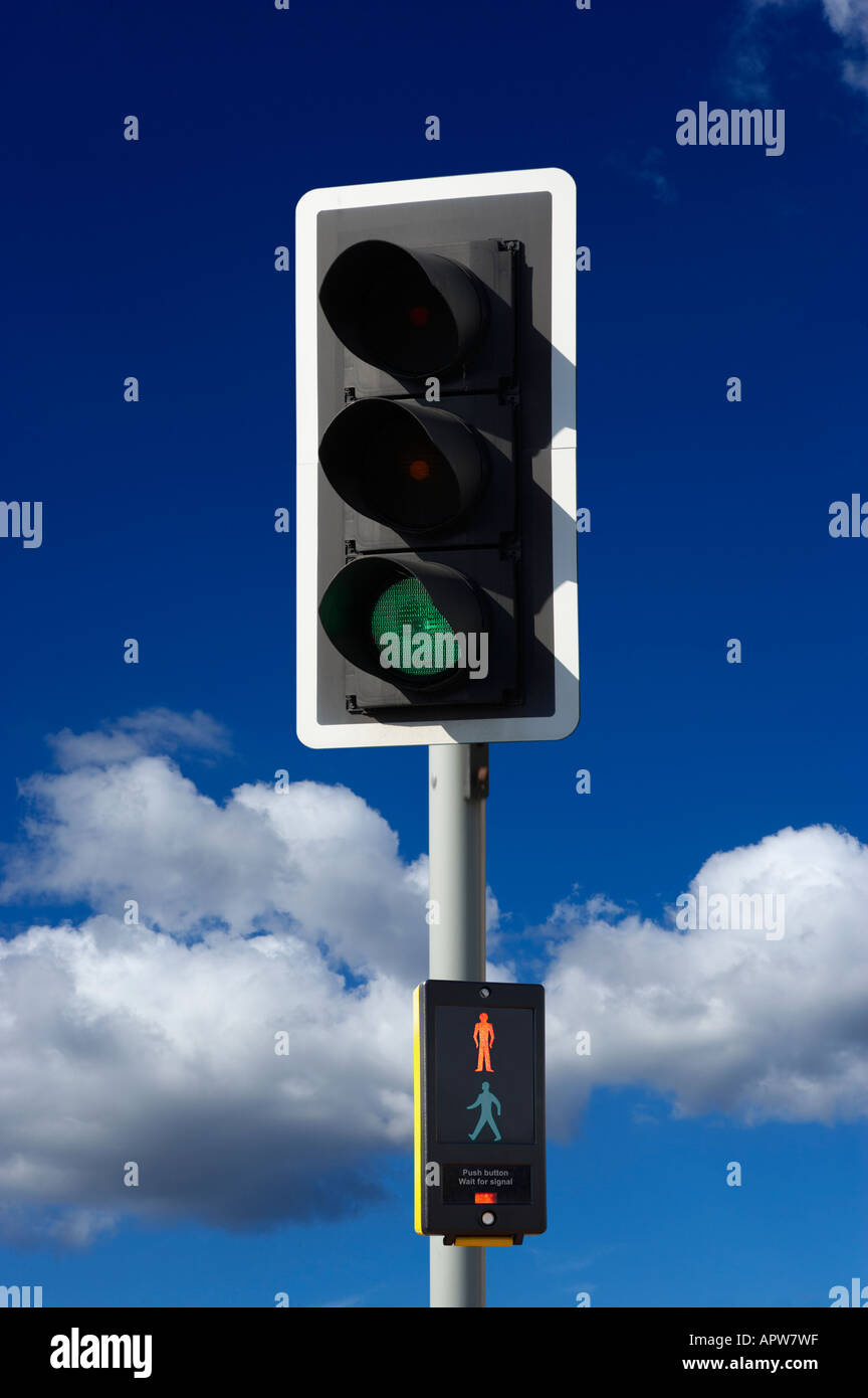 GREEN ROAD TRAFFIC LIGHT AND PEDESTRIAN CROSSING CONTROL BOX WITH BLUE SKY Stock Photo