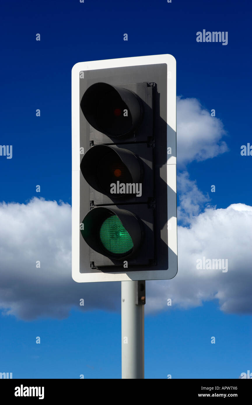 RED AND AMBER GREEN ROAD TRAFFIC LIGHT WITH BLUE SKY Stock Photo