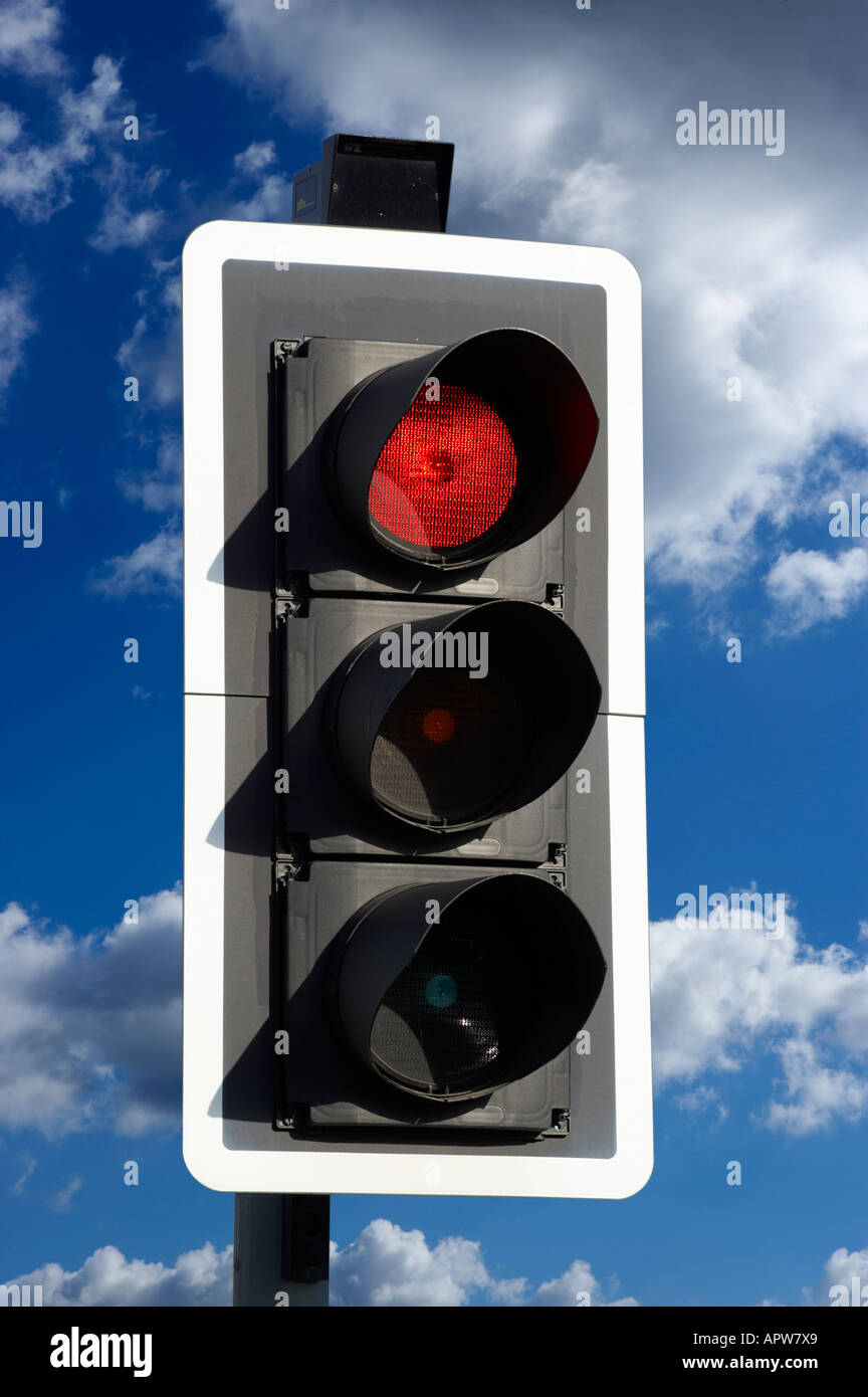 RED ROAD TRAFFIC LIGHT WITH BLUE SKY Stock Photo