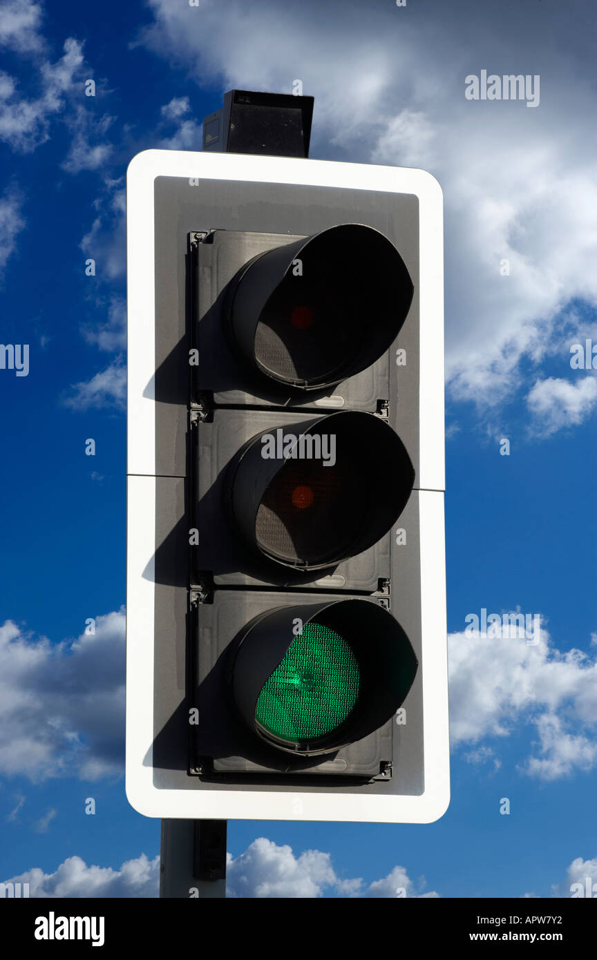 GREEN ROAD TRAFFIC LIGHT WITH BLUE SKY Stock Photo