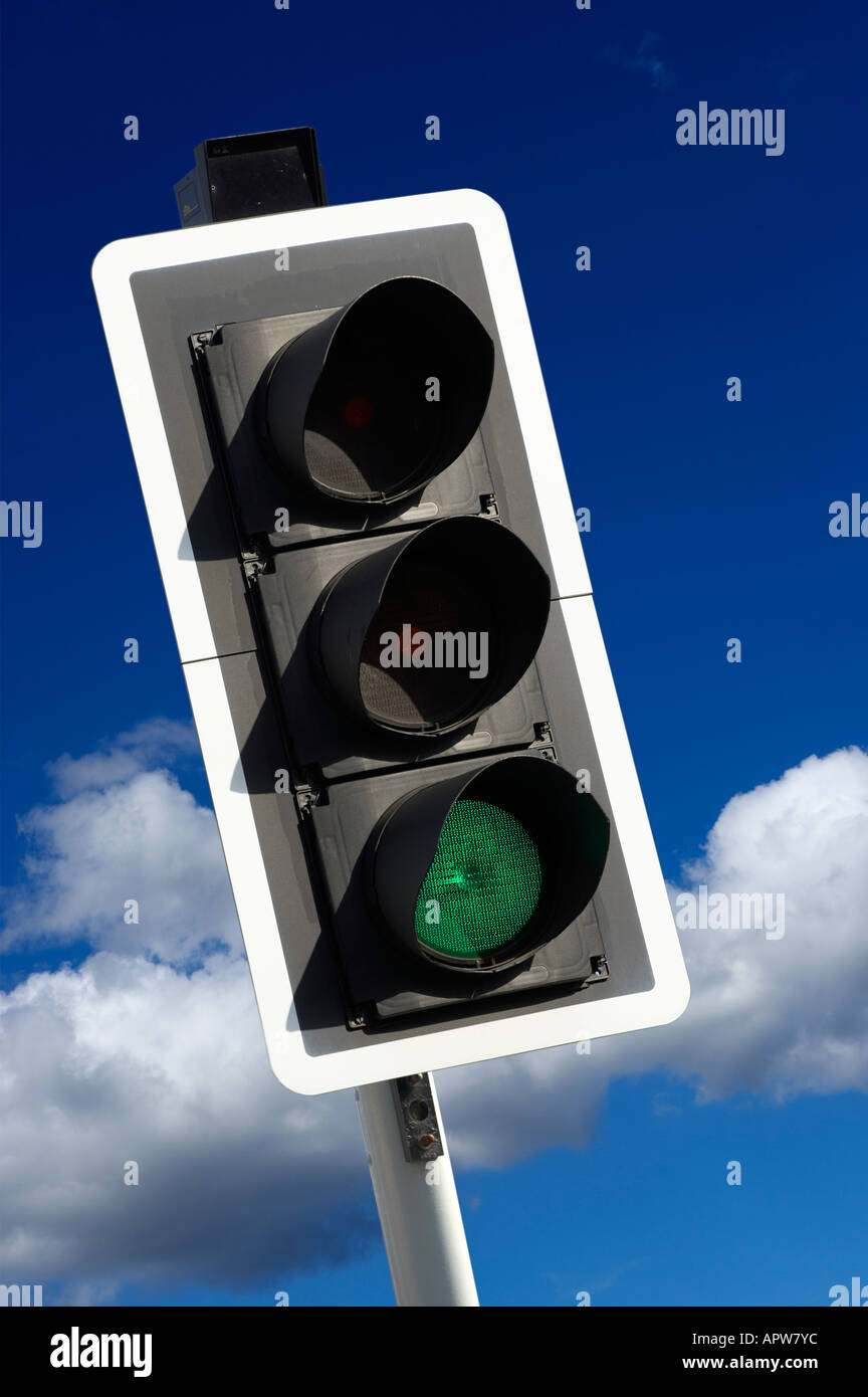 GREEN ROAD TRAFFIC LIGHT WITH BLUE SKY Stock Photo
