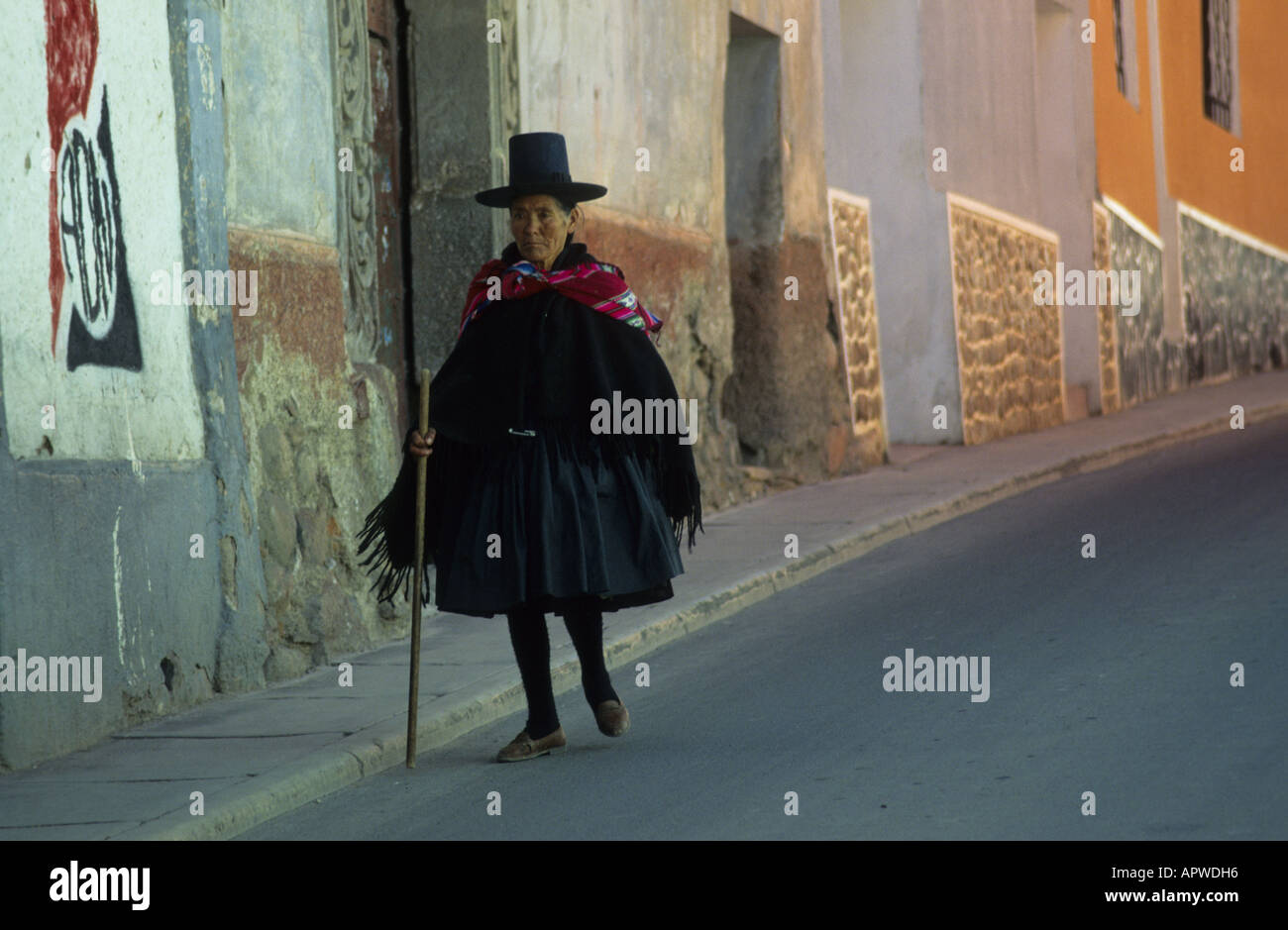 Woman in traditional dress walking in a street in Potosi, Bolivia. Stock Photo