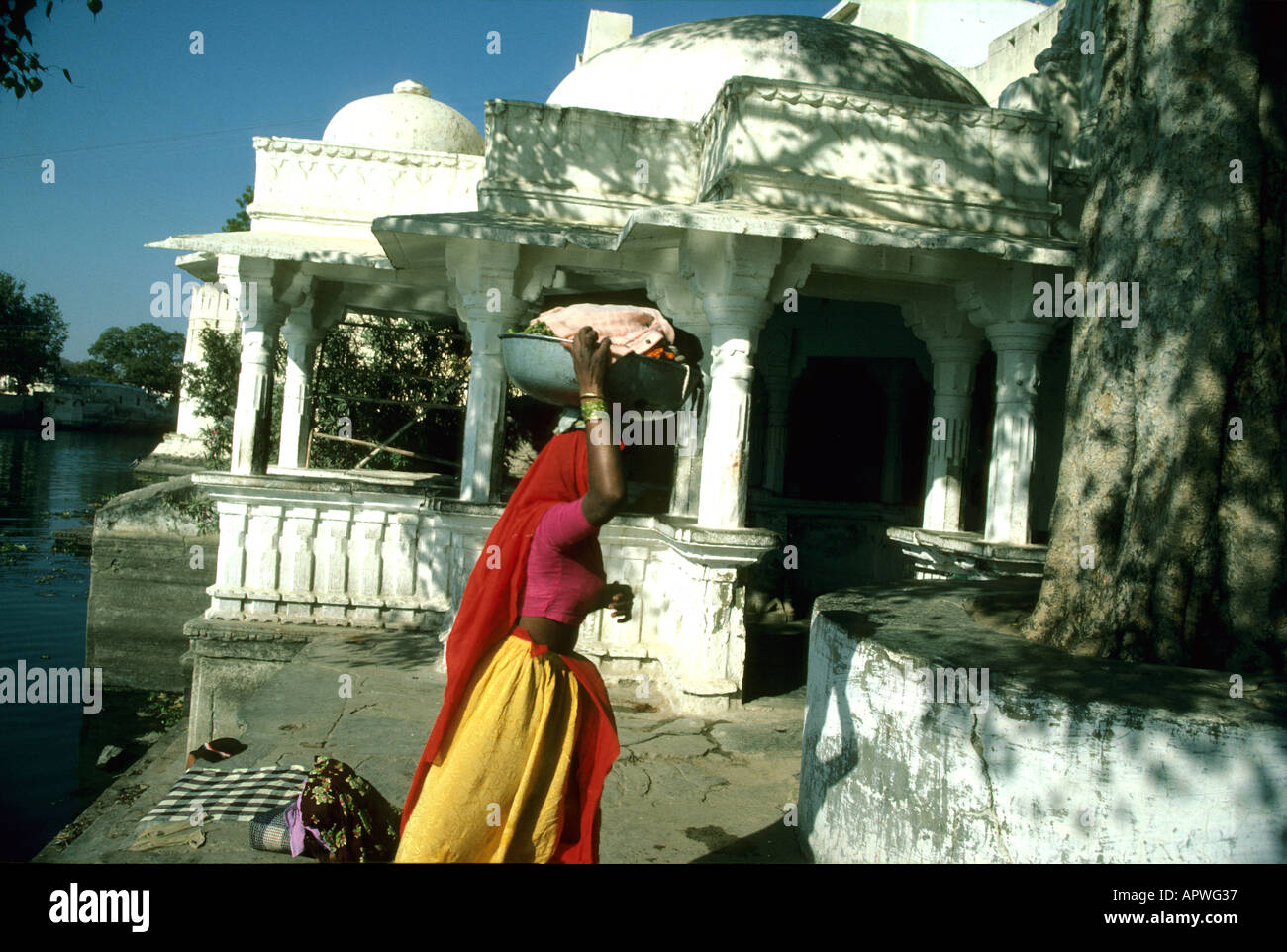 woman walking past white building Stock Photo - Alamy