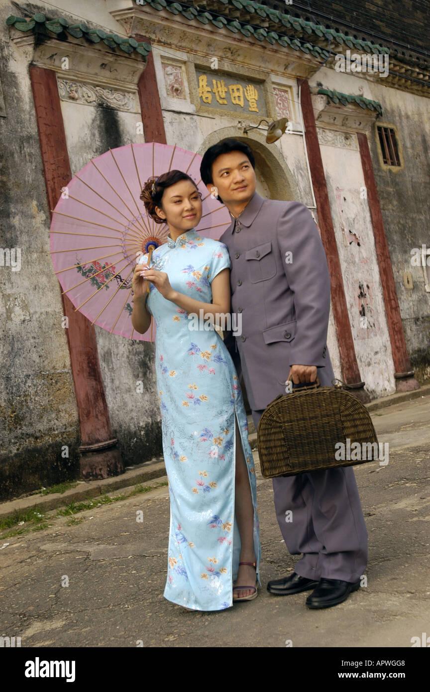 Newly married Chinese couple dressed in old style clothes poses for photographs Stock Photo