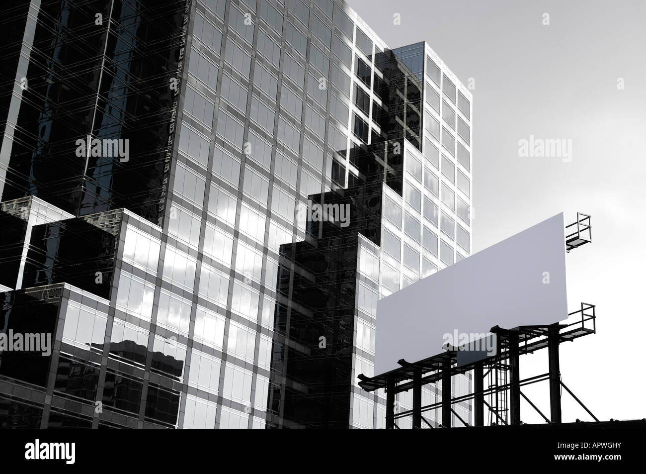 Blank white advertisement banner over high-rise downtown office building Stock Photo