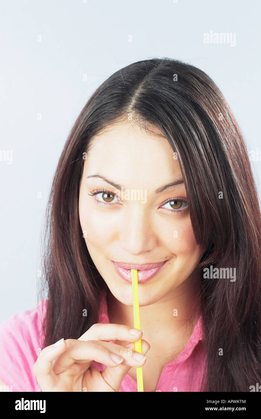 Young woman drinking with straw Stock Photo Alamy