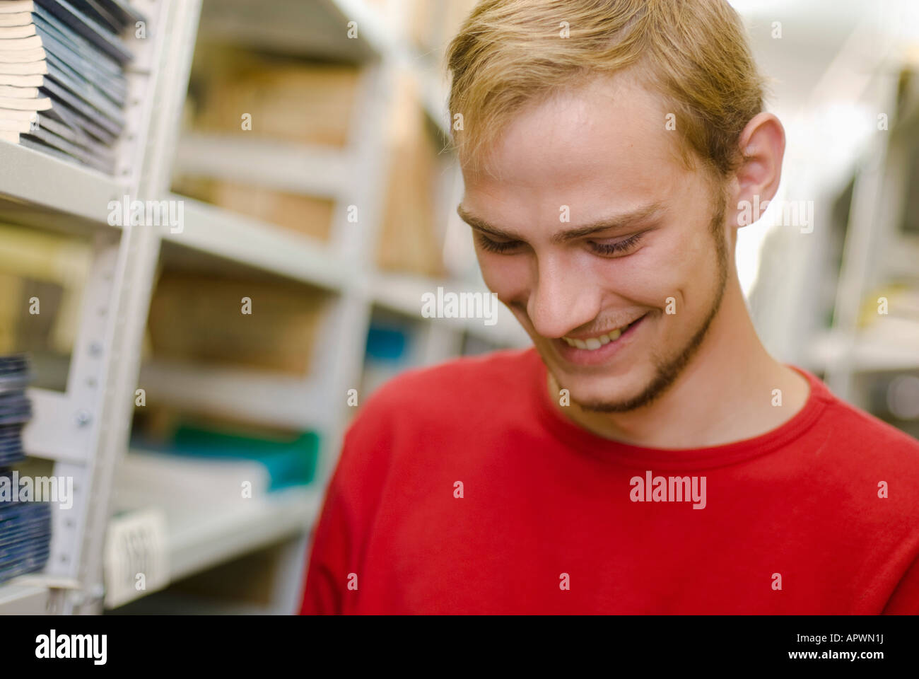 portrait of smiling male student in school library Stock Photo - Alamy