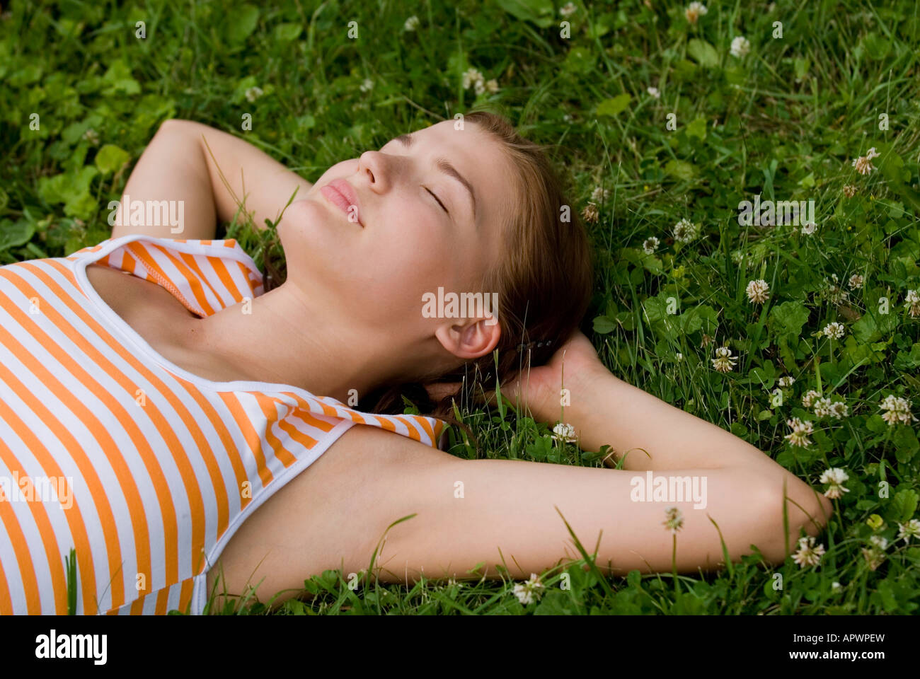 portrait of young woman relaxing on lawn in park Stock Photo - Alamy