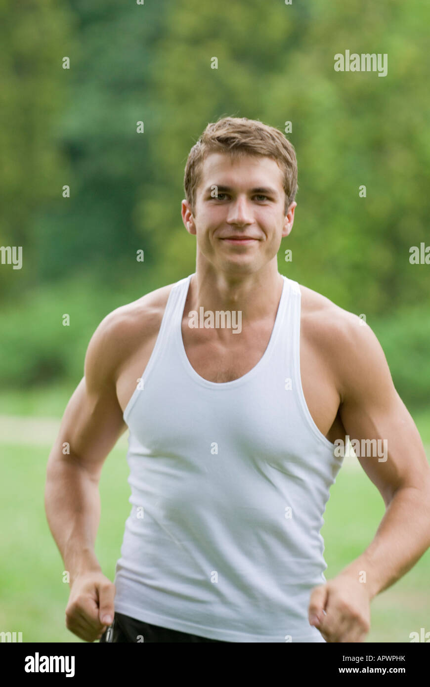 Jogging Portrait portrait of young man jogging through park Stock Photo - Alamy