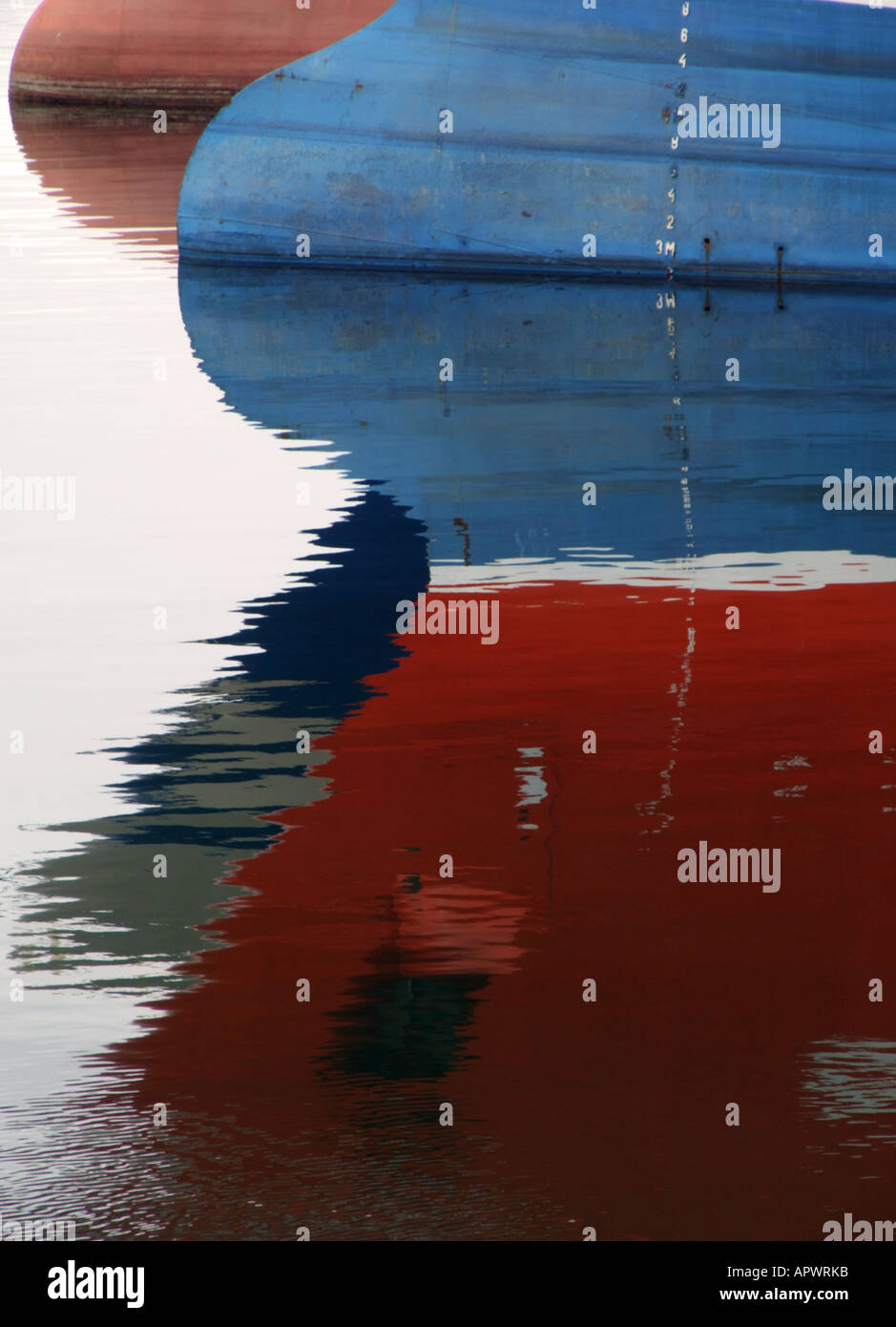 Reflections of fishing boats in the harbour Stock Photo - Alamy