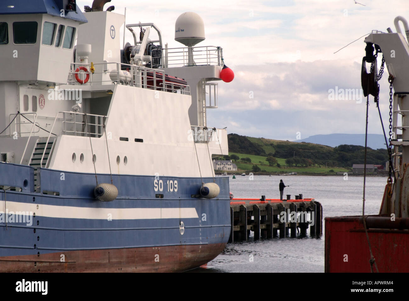 Killybegs County Donegal Ireland A man fishing in the harbour Stock Photo