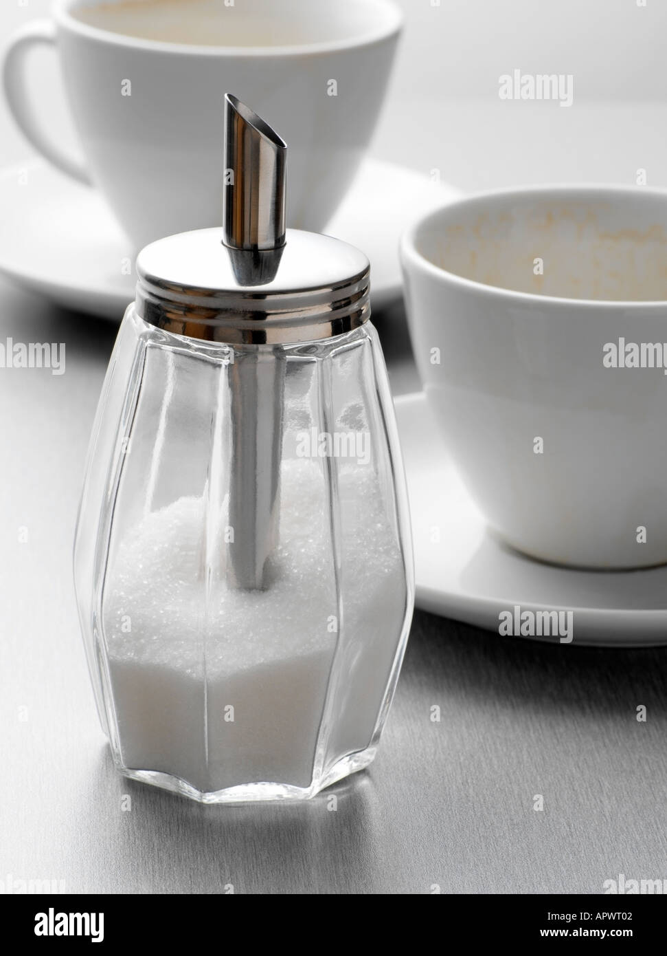 Sugar shaker and cups Stock Photo