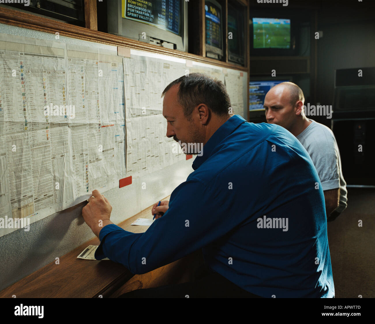Men in a betting shop Stock Photo