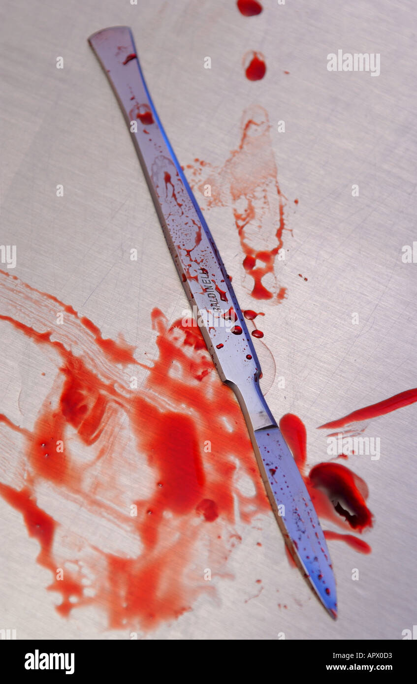 a surgical scalpel with blood on it Stock Photo