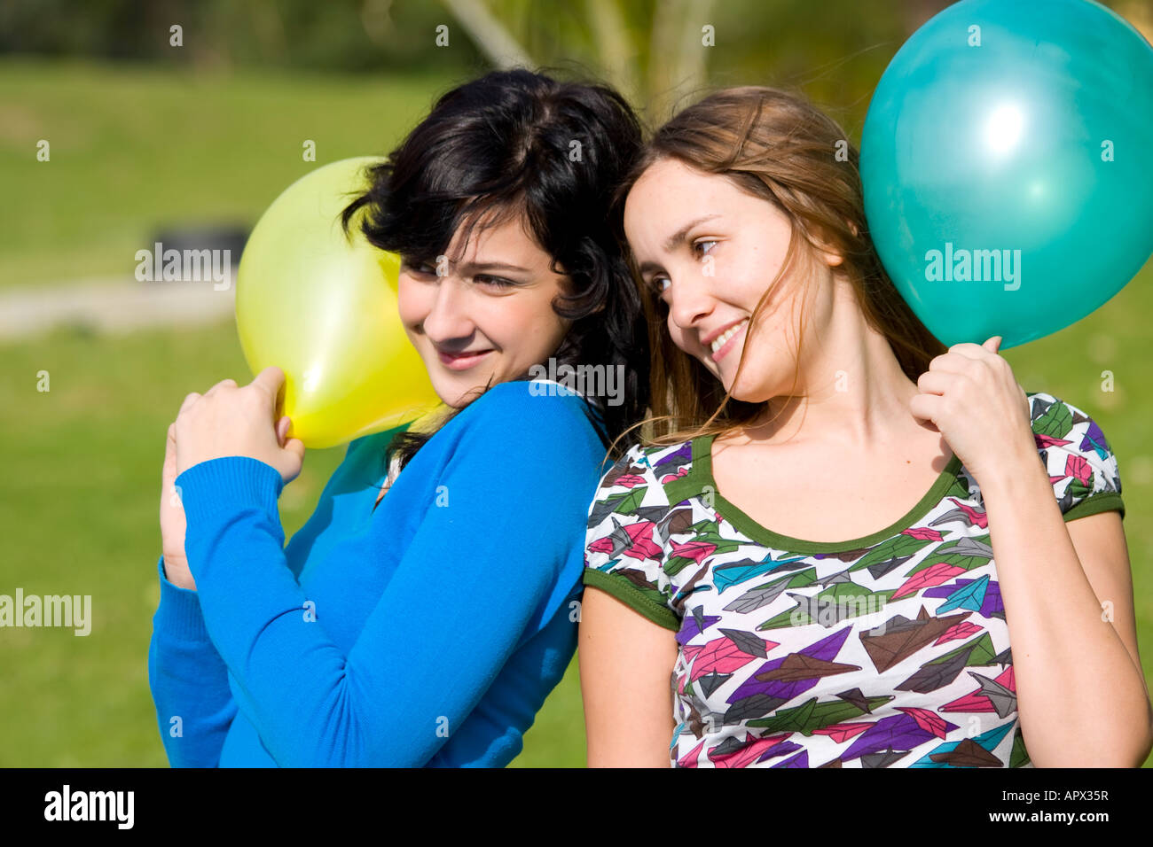 Two smiling girls in the park Stock Photo - Alamy