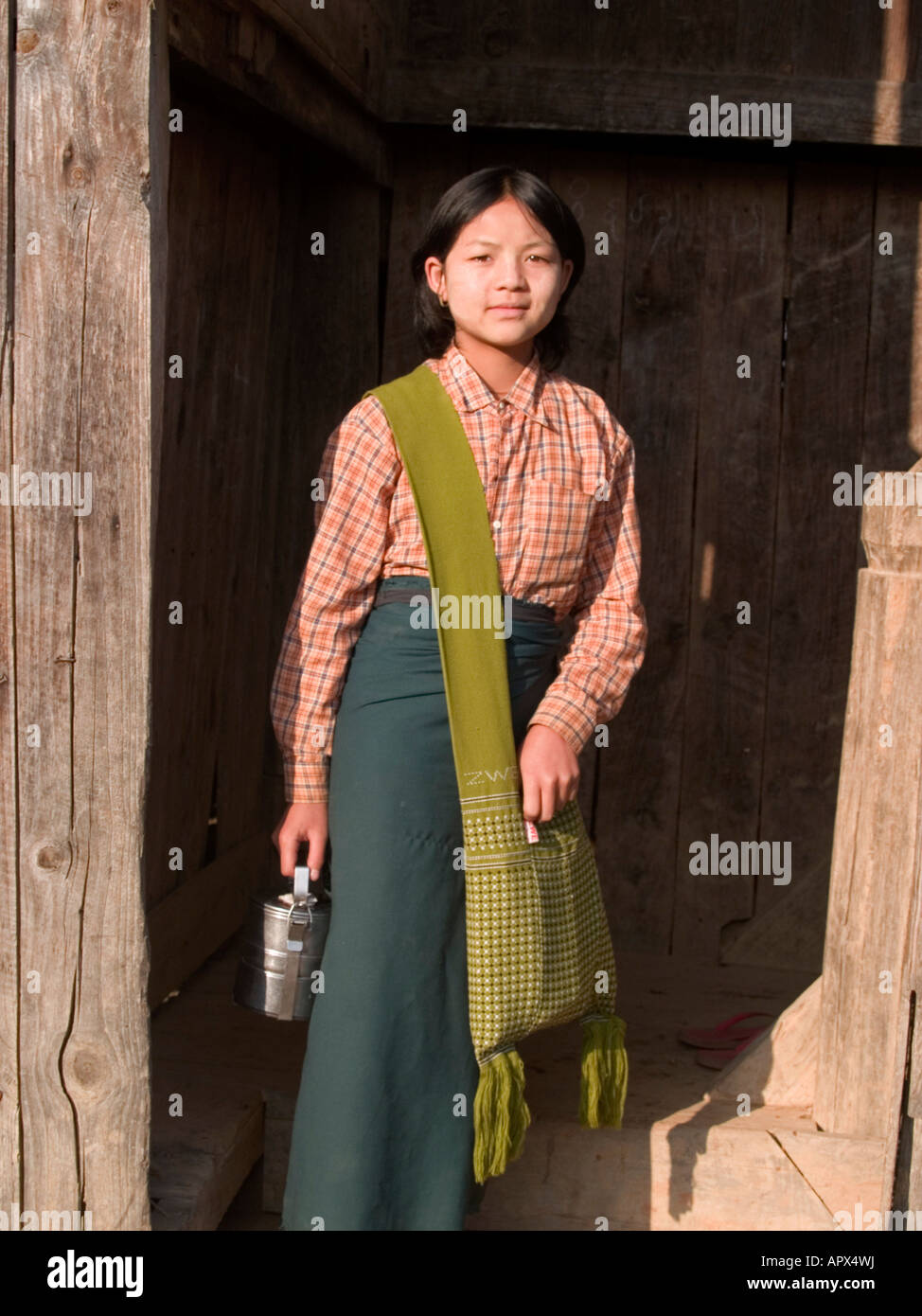 Pa O girl in the Shan State of Myanmar with her lunchbox and school