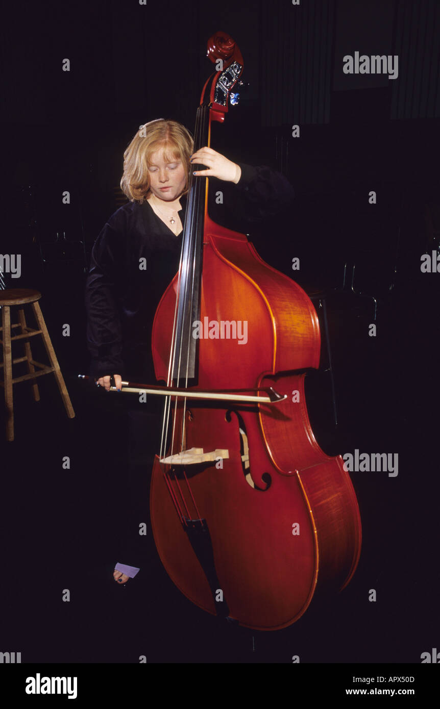 A girl plays an upright bass with a bow Stock Photo Alamy