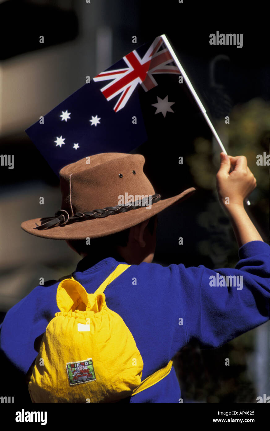 Anzac Day Hyde Park Sydney Australia Boy sitting on Fathers shoulders patriotically waving the Australian flag Stock Photo