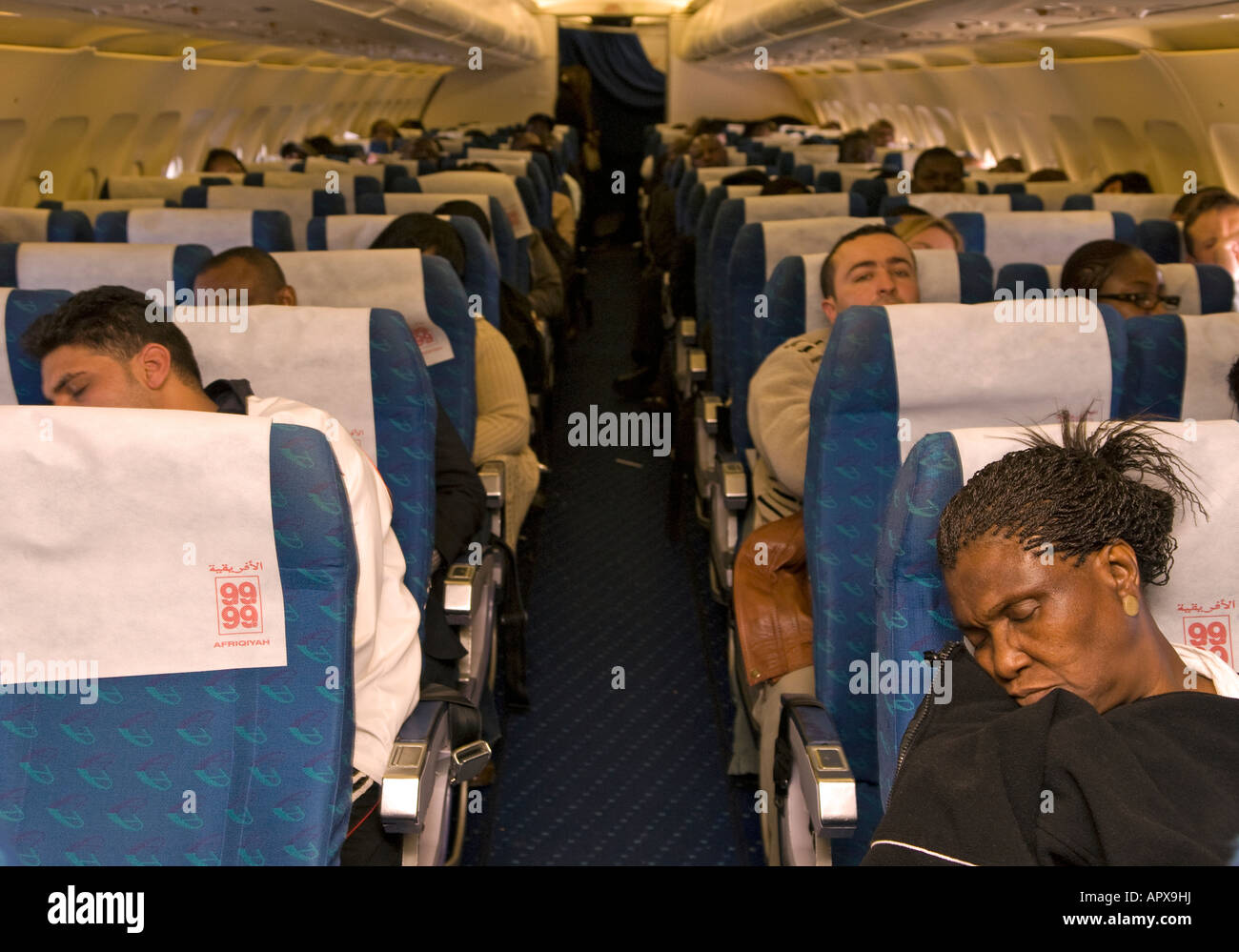 Passengers on an Afriqiyah Airways flight from Tripoli, Libya to London Gatwick on 12th January 2008. Stock Photo
