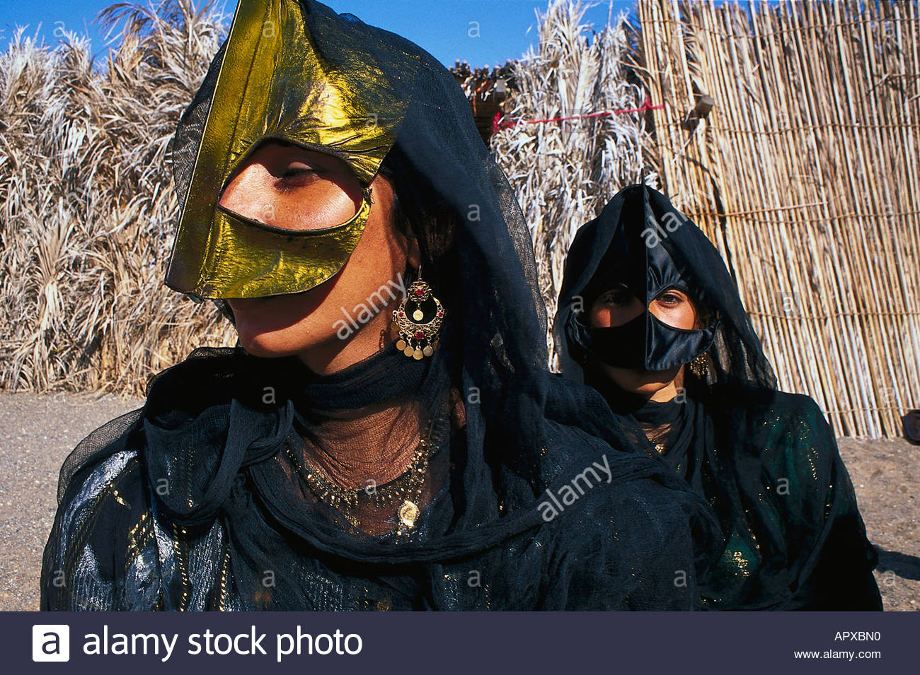 Two bedouin women with traditional veil and mask, Oman Stock Photo