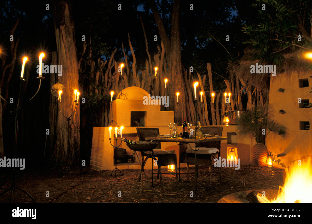 Outdoor dinner by candlelight at Sandibe lodge Stock Photo
