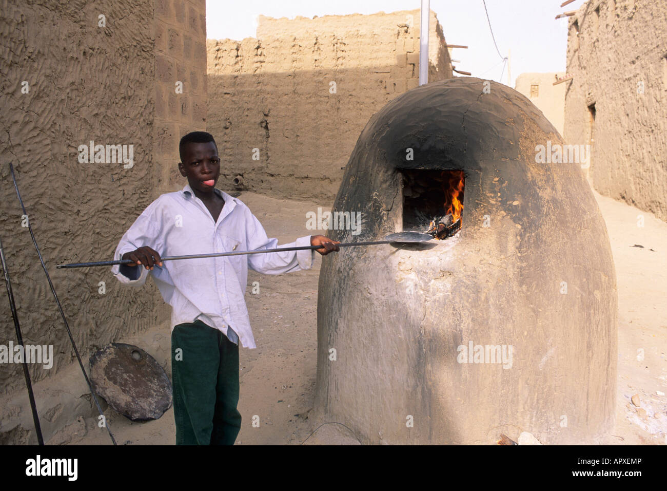 Boy baking in traditional oven Stock Photo