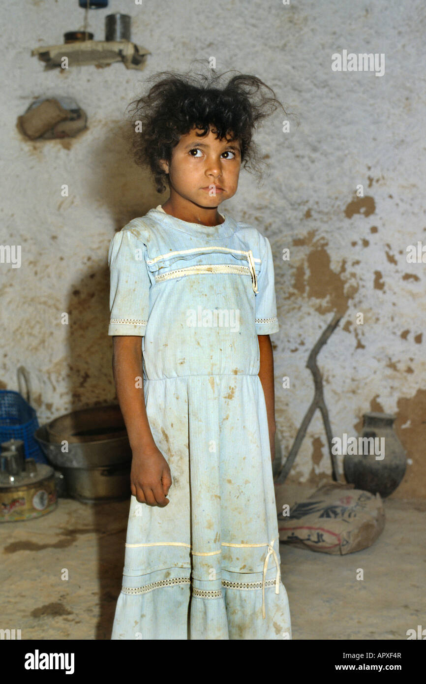 Young Tunisian girl with unkempt hair and dirty dress Stock Photo