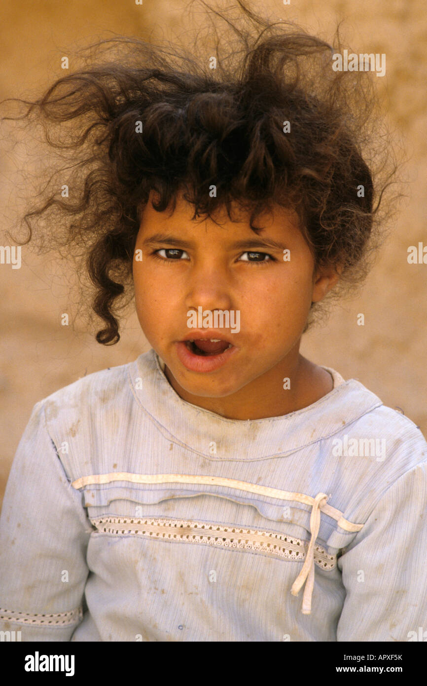 Portrait of a young Tunisian girl with unkempt hair and dirty dress Stock Photo