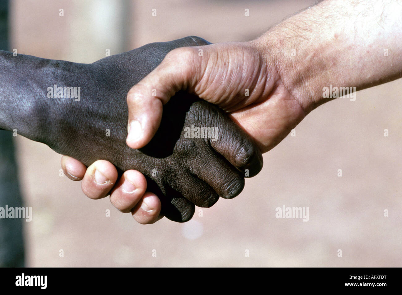 Close up of a handshake betweeen a black and white person Stock Photo