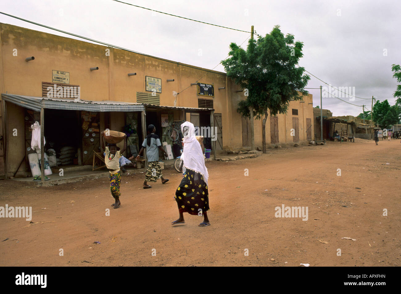Woman walking across village hi-res stock photography and images - Alamy