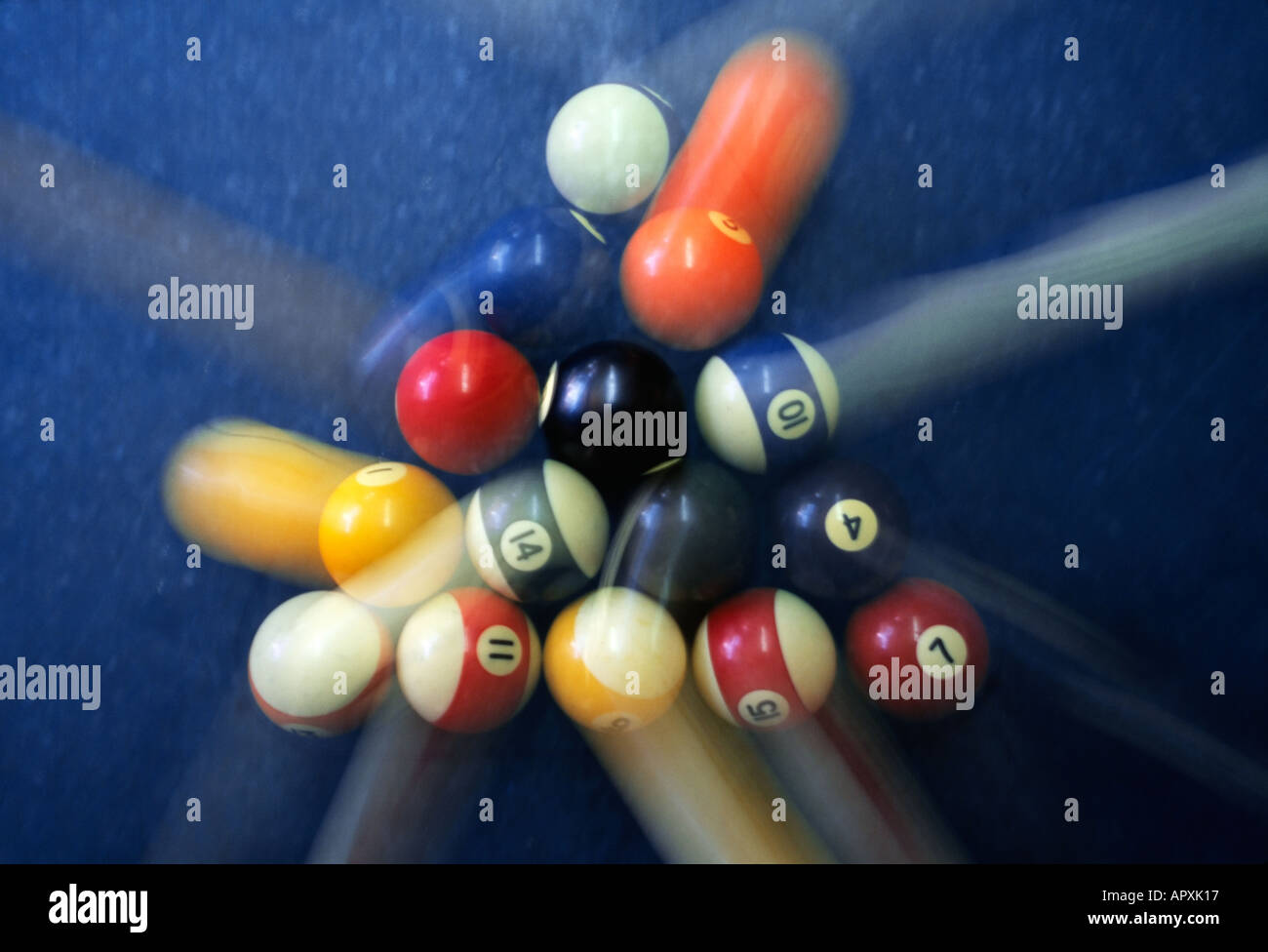 Pool balls colliding into one another with blurred motion Stock Photo
