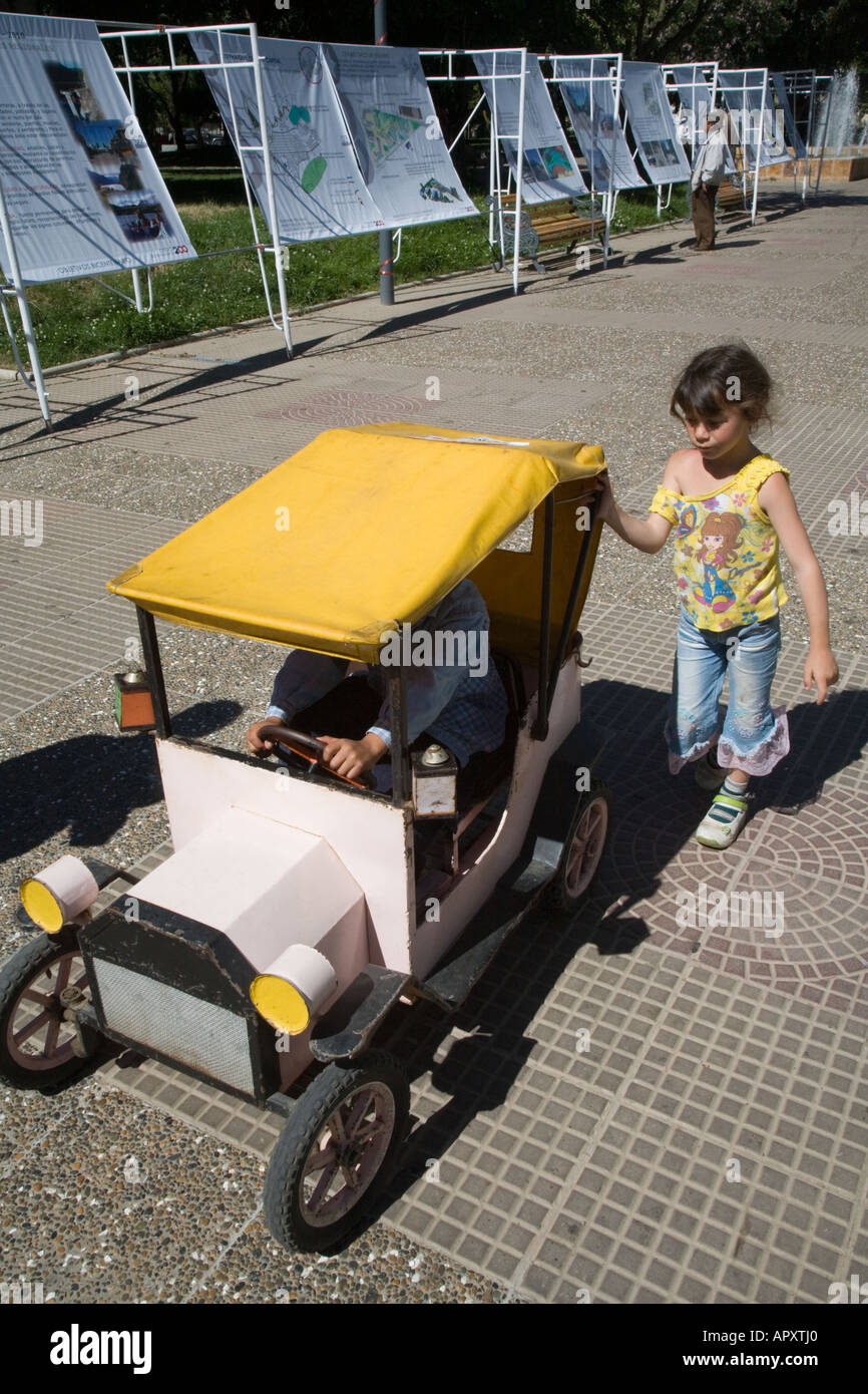Children riding peddle cars in park Coihaique Patagonia Chile Stock Photo