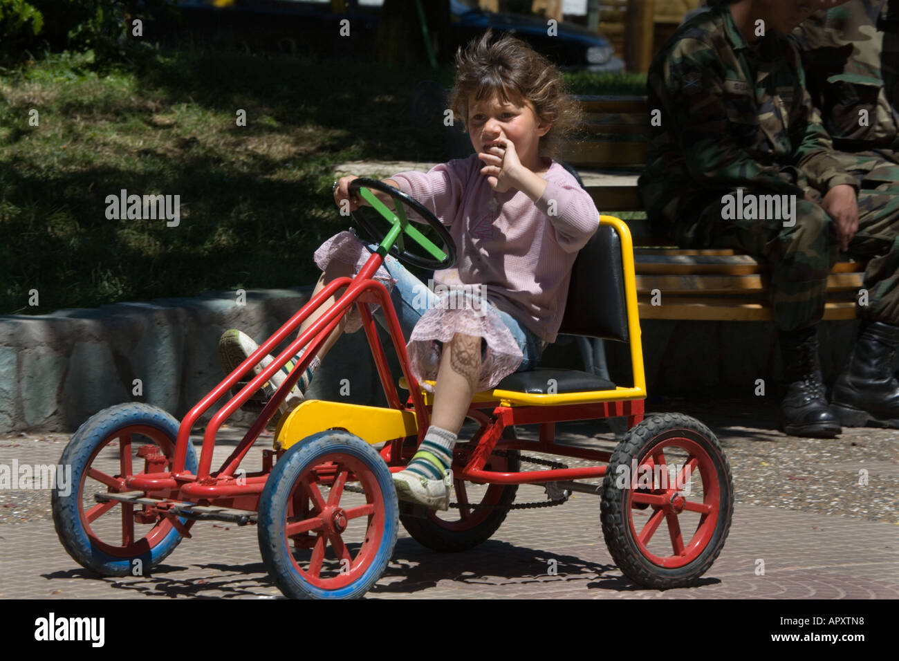 Child riding peddle cars in park Coihaique Patagonia Chile Stock Photo