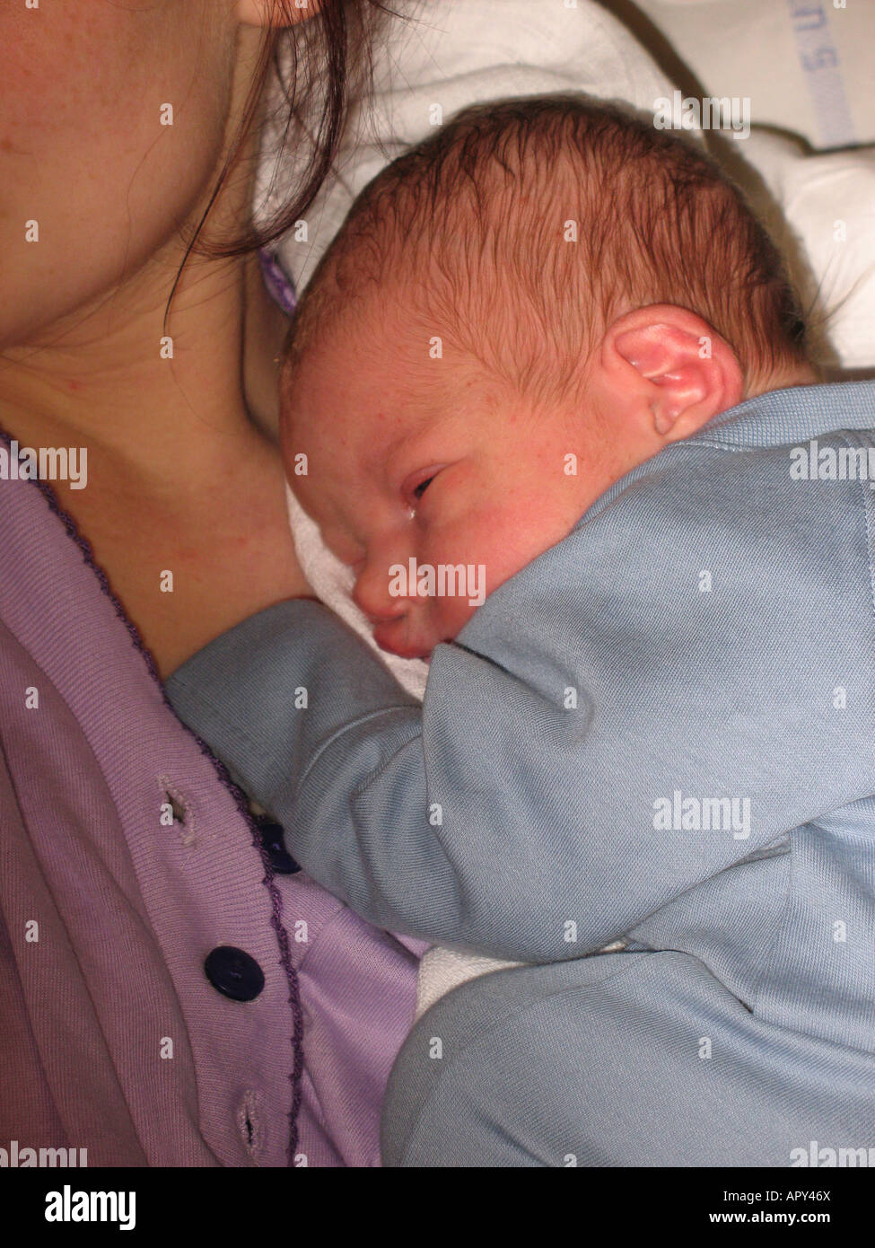 Mother and newborn son sharing a cuddle Stock Photo Alamy