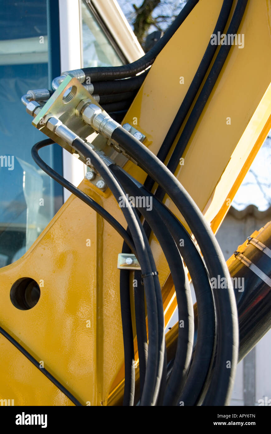 Close up shot of the hydraulic cables on the arm of a digger Stock