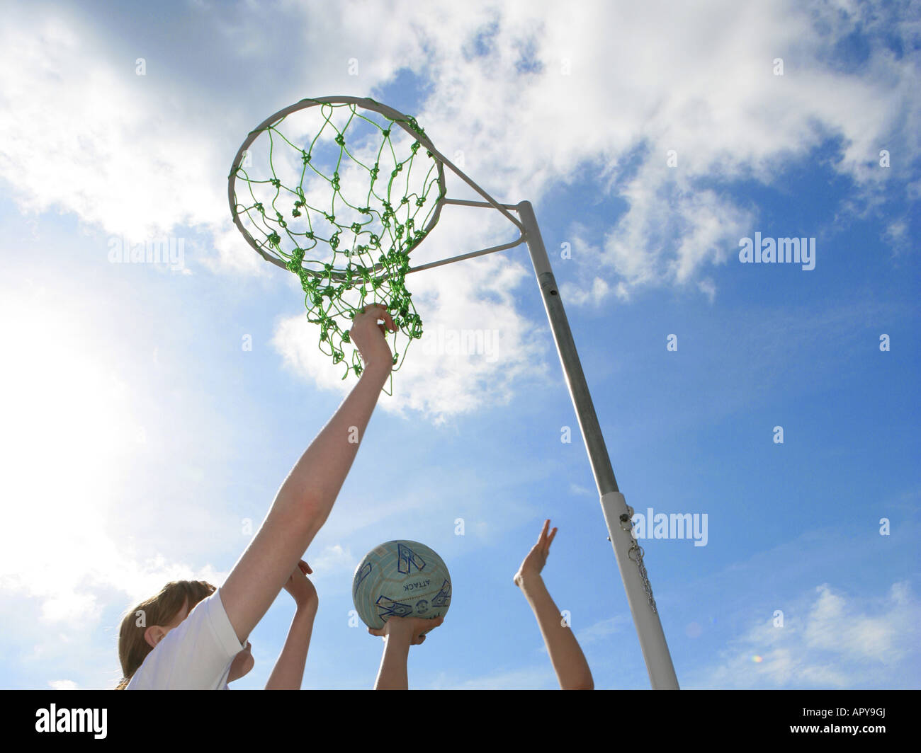 Netball hands in blue sky Stock Photo