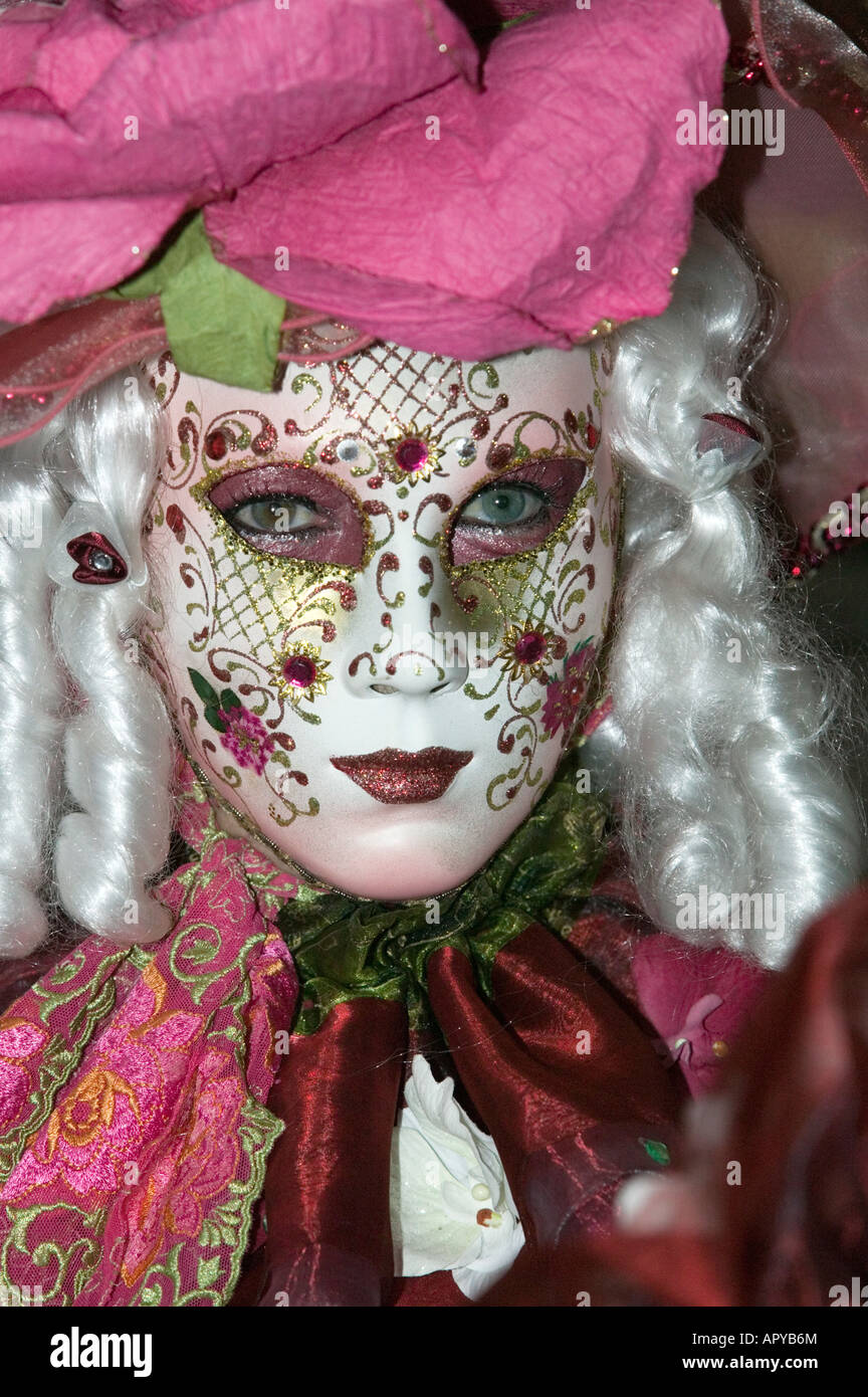 Carnival in Venice - Woman with white curls and white mask decorated with flowers Stock Photo