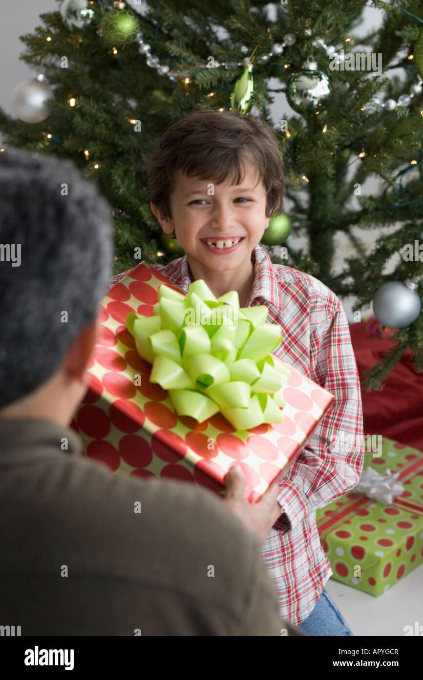 Hispanic boy giving Christmas gift to father Stock Photo Alamy