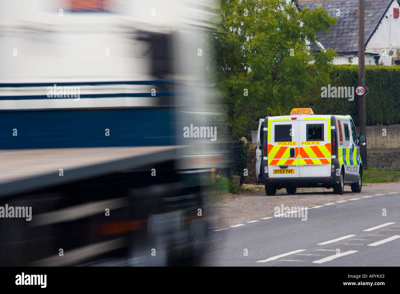 Truck speeding past 30 mph police mobile speed trap traffic safety JMH1763 Stock Photo