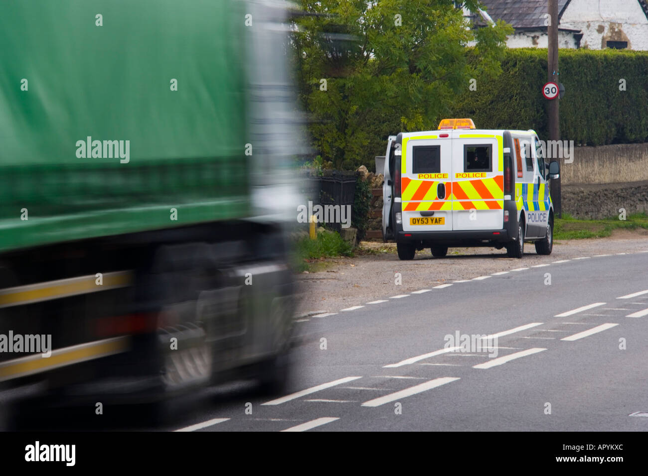 Truck speeding past 30 mph police mobile speed trap traffic safety JMH1764 Stock Photo