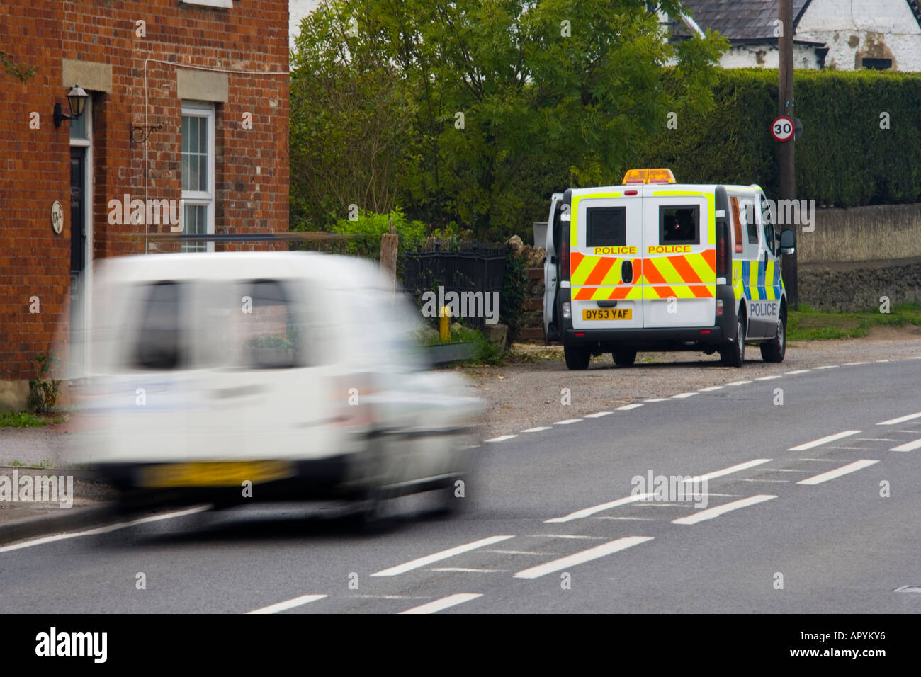 White van speeding past 30 mph police mobile speed trap traffic safety JMH1765 Stock Photo