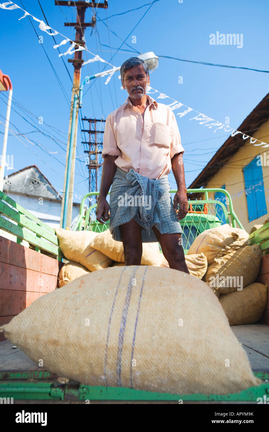 INDIA KERALA COCHIN SPICE TRADER WITH SACKS OF SPICES ON DELIVERY TRUCK Stock Photo