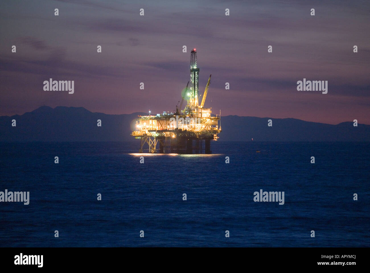 Nighttime image of an oil rig off the coast of California, with the ...