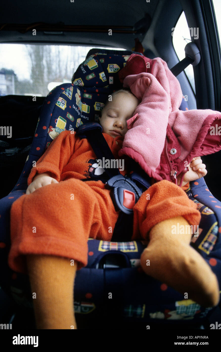 Boy one years old sleeping deeply in a car Stock Photo