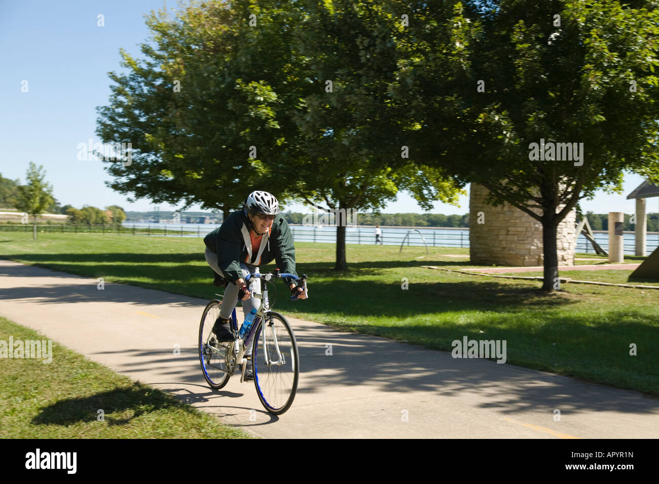 IOWA East Davenport Adult woman riding bicycles along Great River Trail paved path along Mississippi River Stock Photo