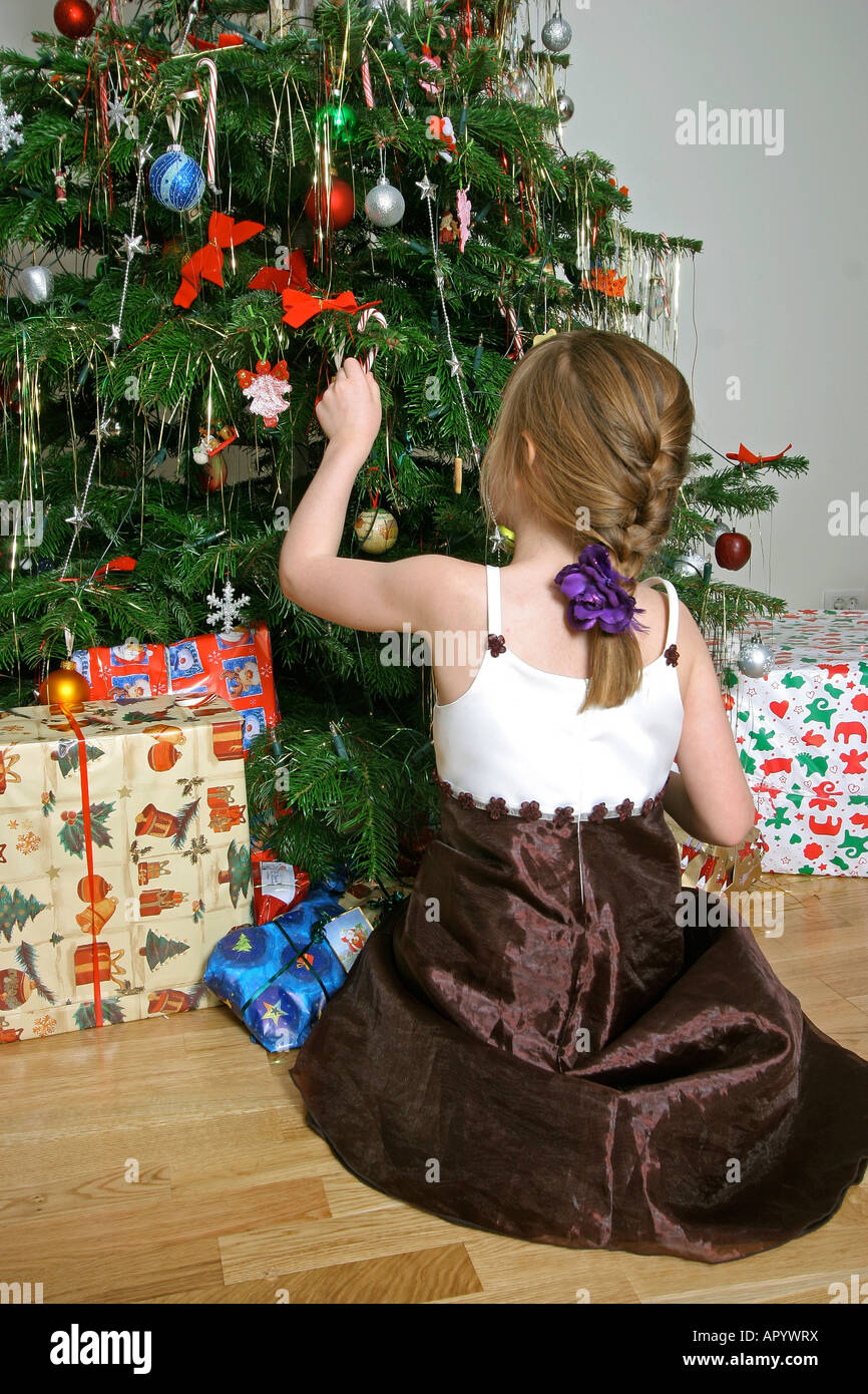 Young girl in front of the christmas tree Stock Photo