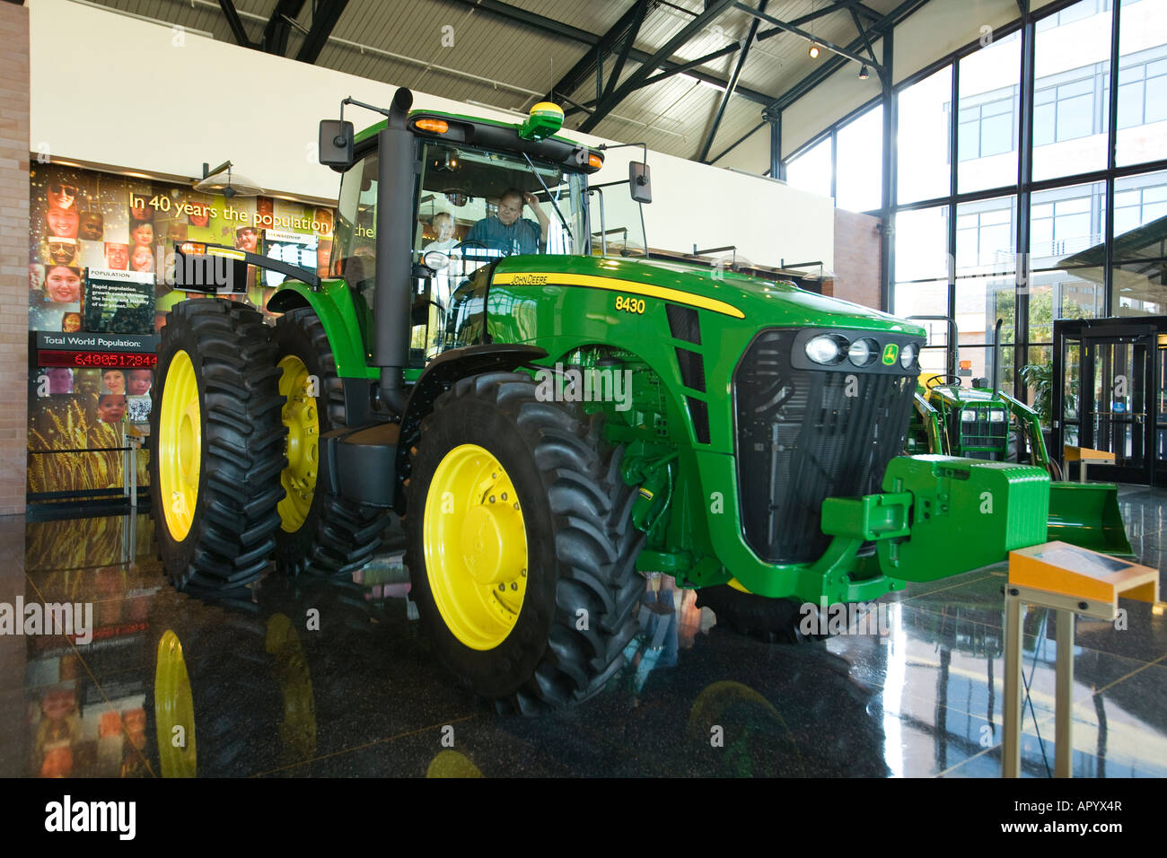 ILLINOIS Moline Man and son sit in cab John Deere tractor displayed in Pavilion farming and agricultural equipment Stock Photo