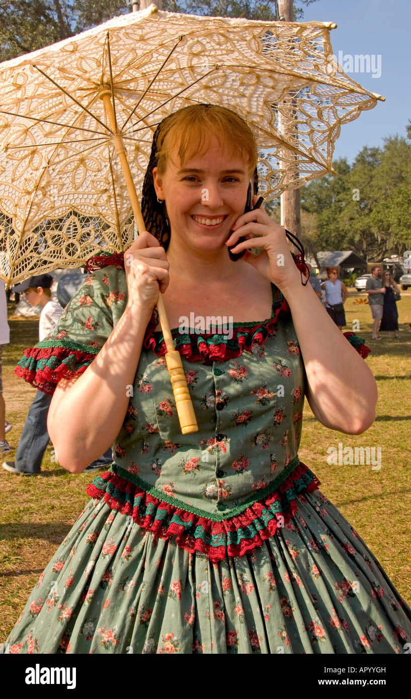 Woman in Civil War era clothing on cell phone Stock Photo